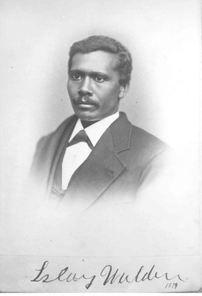 Black and white photo of a man wearing a suit. He has a calm expression on his face. Photograph is labeled &quot;Islay Walden 1879&quot; in cursive handwriting at bottom of image. 