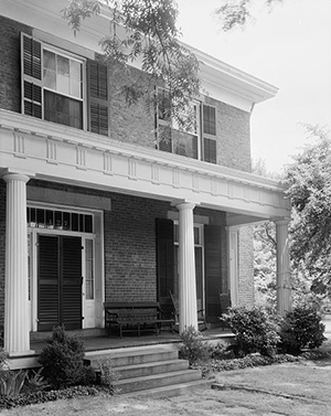 A house with a large columned porch.