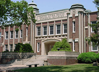 A large building, bearing Rhyne's name. It is brick with beige trim.