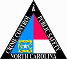 A triangular depiction of the North Carolina flag.  A thick black triangle outlines the flag and words on the triangle read &quot;Crime Control & Public Safety North Carolina.&quot;