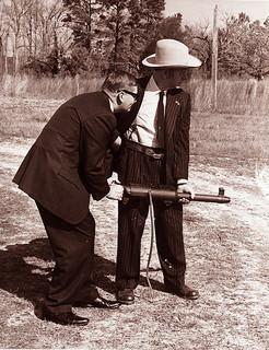 Governor Terry Sanford and David Marshall &quot;Carbine&quot; Williams with a machine gun, c.1971. From the General Negative Collection, North Carolina State Archives, call #:  N_71_11_172 , Raleigh, NC.