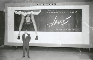 &quot;Gordon Hanes, of Hanes Corporation, in front of a Hanes Hosiery billboard, 1956.&quot; Image courtesy of DigitalForsyth. 