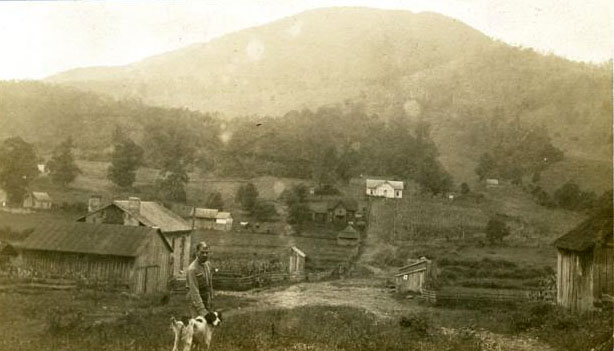Photograph of a small farming community in Jefferson, N.C. with Mount Jefferson in the distance, ca. 1920.  The mountain was given the name &quot;Mount Jefferson&quot; at the time the park was created in 1956. Item H.19XX.313.27 from the collection of the N.C. Museum of History. 