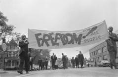 African American men carrying a freedom banner