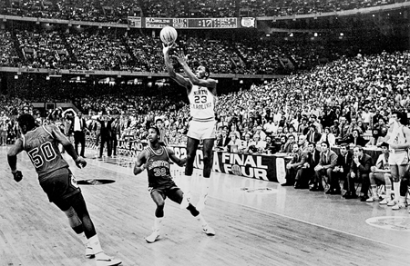 Michael Jordan, as a UNC freshman, launches the winning shot against the Georgetown Hoyas in the 1982 NCAA championship game in New Orleans. Photograph by Allen Dean Steele. Raleigh News and Observer.