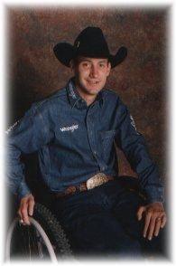 Jerome C. Davis seated in a wheelchair. He is wearing a cowboy hat and is smiling.