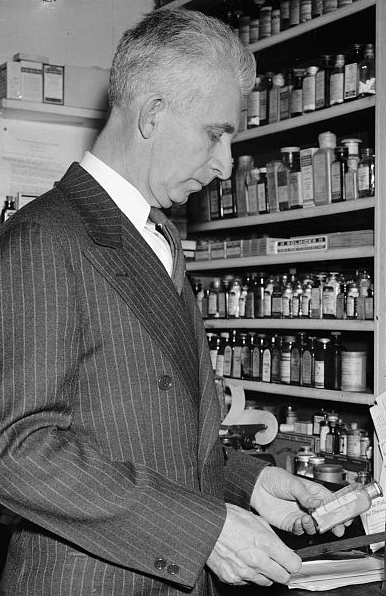 Harris & Ewing. &quot;Only Druggist in Congress. Washington, D.C., Feb. 13. While many professions and businesses are represented in the 76th Congress, Rep. Carl T. Durham, democrat of North Carolina, is the only pharmacist in that august body. He ran a drug store at Chapel Hill before his election to the house, 2-13-39&quot;. Photograph. 1939 February 13. LC-H22-D- 5782. Prints and Photographs Division, Library of Congress.