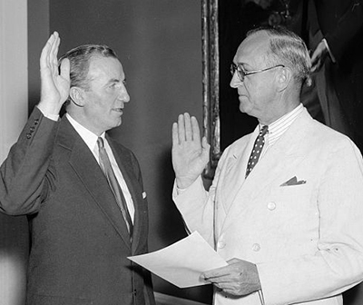 Harris & Ewing. &quot;Hanes [left] takes oath as Assistant Secretary of Treasury. Washington, D.C., July 1. John W. Hanes, former New York broker and member of the S.E.C., pictured taking the oath of office today as Assistant Secretary of The Treasury from Frank Birgfeld, Chief Clerk ...&quot;. Photograph. July 1, 1938. LC-H22-D- 4206. Prints and Photographs Division, Library of Congress.