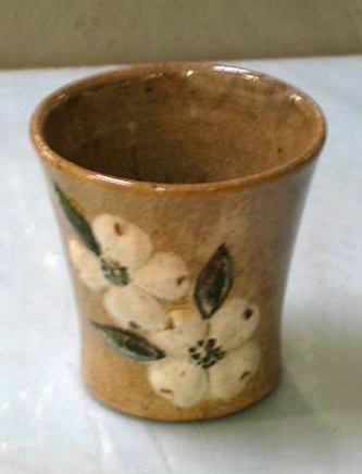 A 1940 cup by Ernest Auburn Hilton, decorated with raised white dogwood blossoms. &quot;Cup, Accession #: H.1969.144.14.&quot; 1940. North Carolina Museum of History.