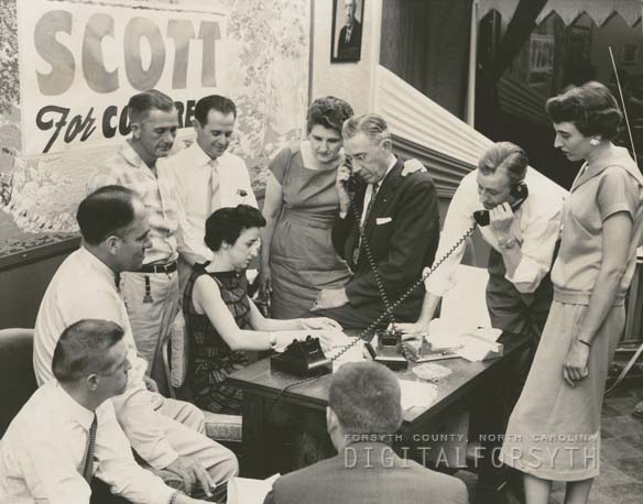 &quot;Ralph Scott headquarters for his congressional renomination, 1958. Mr. Scott is the man on the left talking on the telephone. His wife stands beside him. Mr. Scott won the renomination election,&quot; from Digital Forsyth, published 1958 by Forsyth County Public Library. Presented on Digital Forsyth.