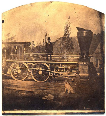 Photograph of the &quot;Romulus Saunders,&quot; an early locomtive of the Raleigh & Gaston Railroad, image circa 1870-1890. Item  H.19XX.135.38, from the North Carolina Museum of History.  Gaston HIllary Wilder was president of the Raleigh & Gaston Railroad beginning in 1858. 