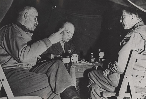 &quot;General Wyche (right) lunches with Gens. Bradley and Eisenhower in Normandy, less than a month after the Allied invasion&quot;. 1944. Image courtesy of ECU Libraries. 